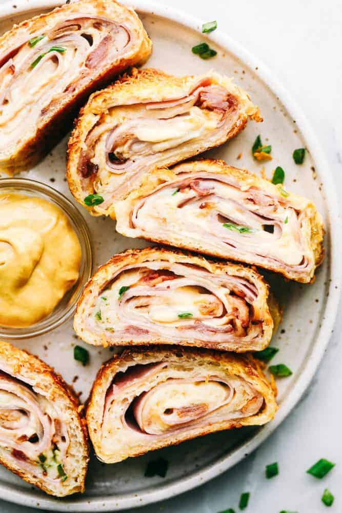 Ham and Swiss Stromboli on a white plate. 