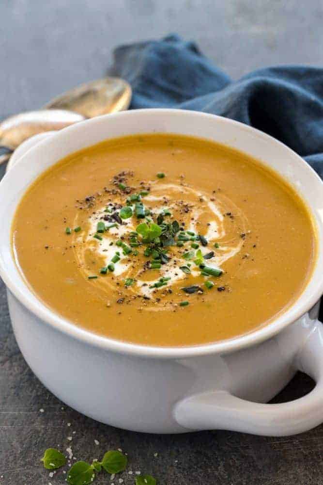 White bowl of potato leek soup.