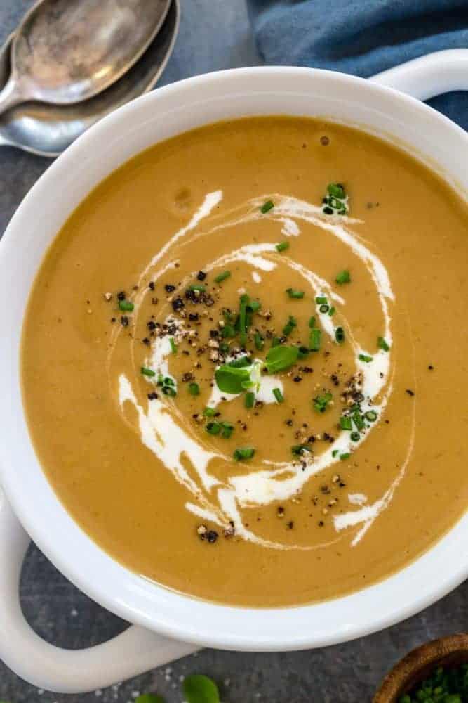 Top down photo of a white bowl with potato leek soup.