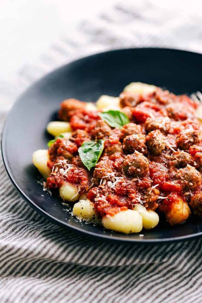 Sausage Tomato Gnocchi in a black bowl.