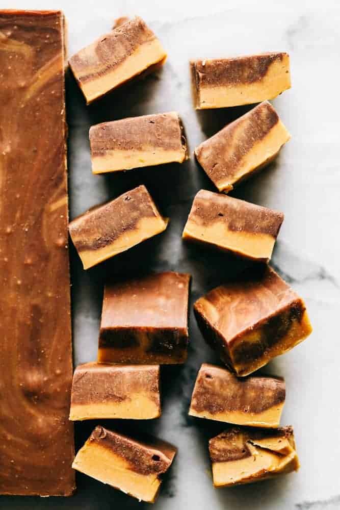 Peanut butter chocolate fudge stacked upward showing the different swirls of peanut butter and chocolate fudge.