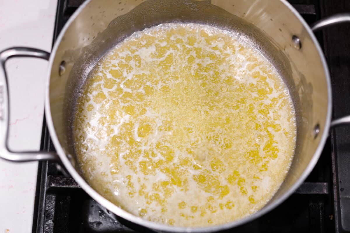 Overhead shot of melted butter in a saucepan. 