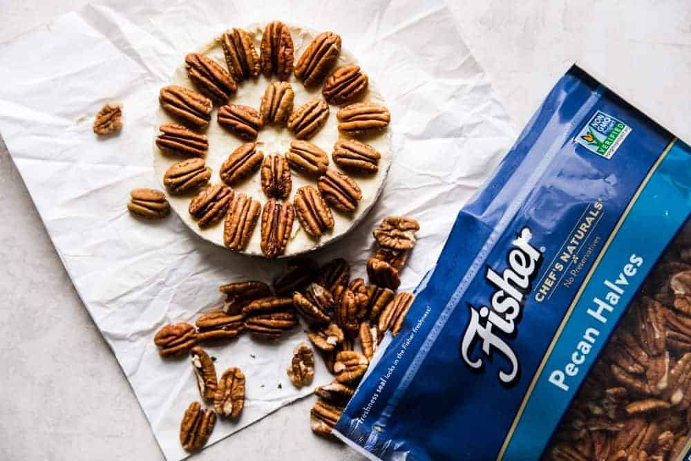 Brie wheel with Fishers pecan halves placed on top.