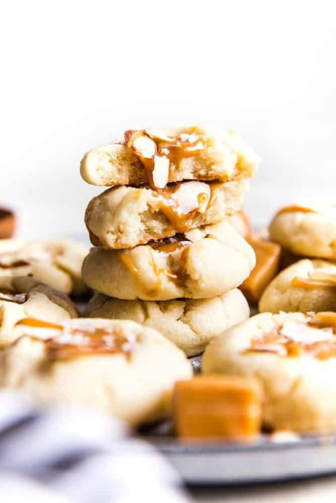 Allman thumbprint cookies stacked on top of each other on a plate.