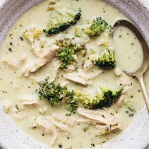 Creamy chicken broccoli soup in a bowl with a spoon