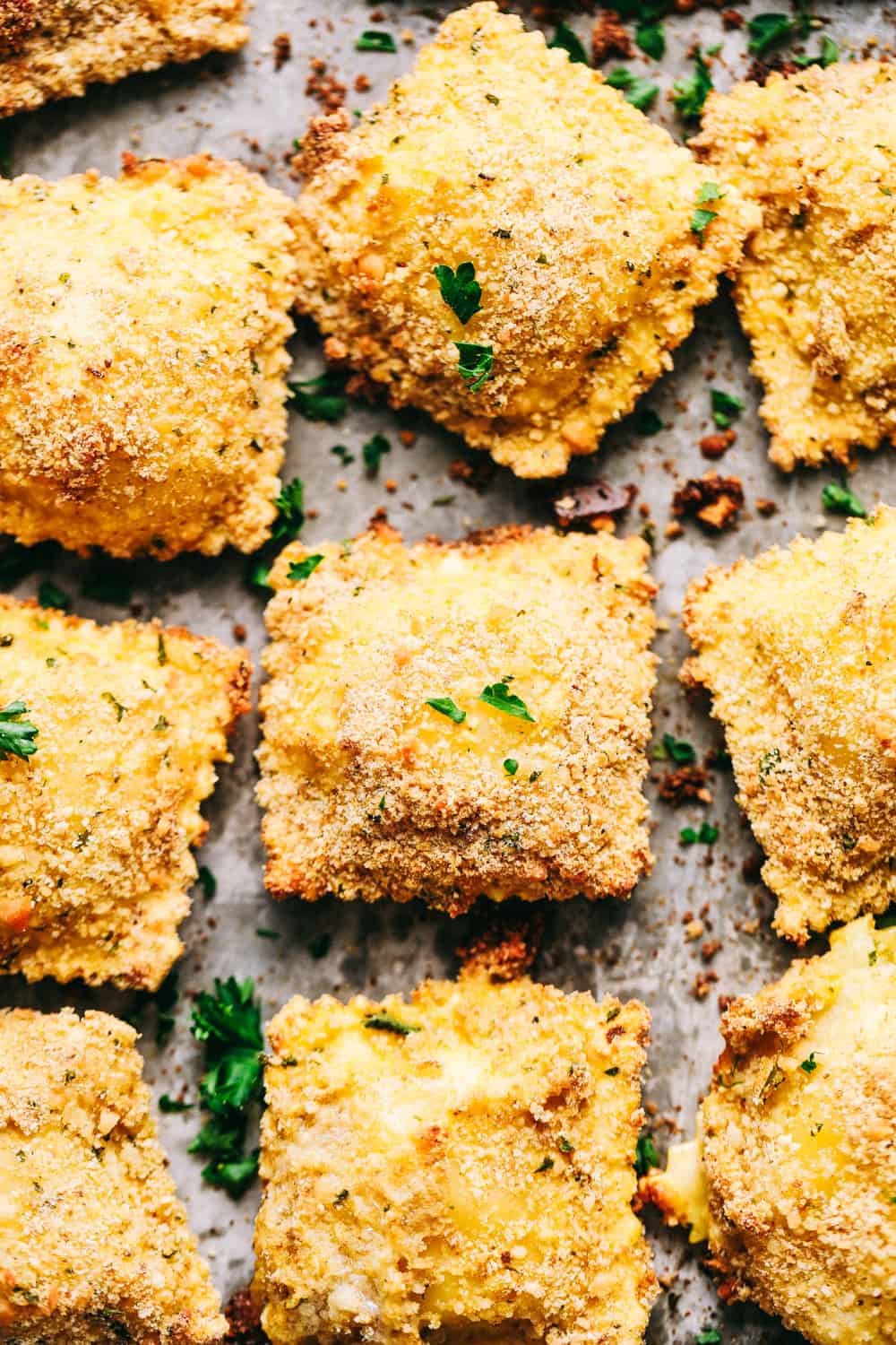 Crispy Baked Parmesan Ravioli in rows on a baking sheet.