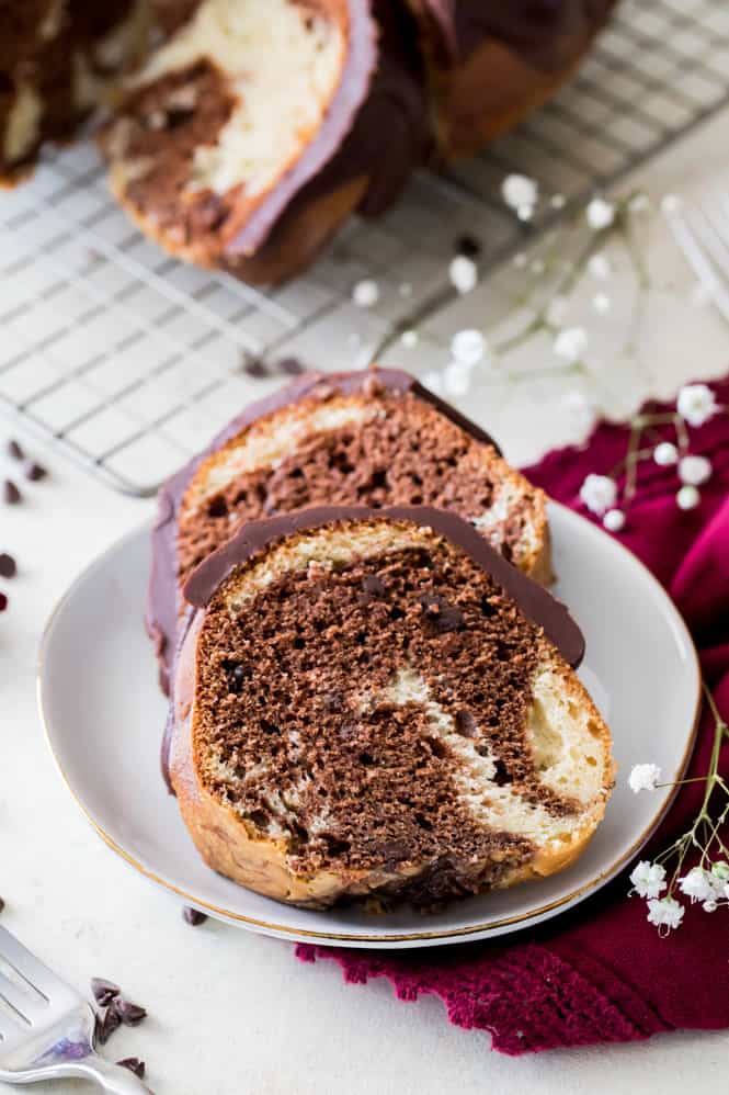 Two slices of cake on a plate.