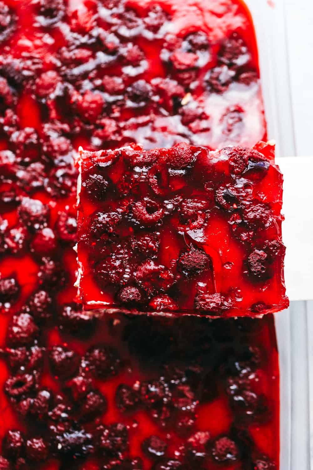 Cutting a slice of Raspberry Pretzel Salad 