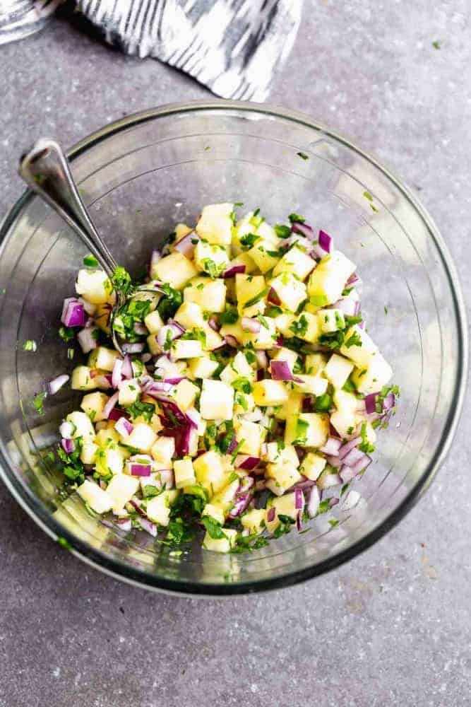 Pineapple salsa in a glass bowl.