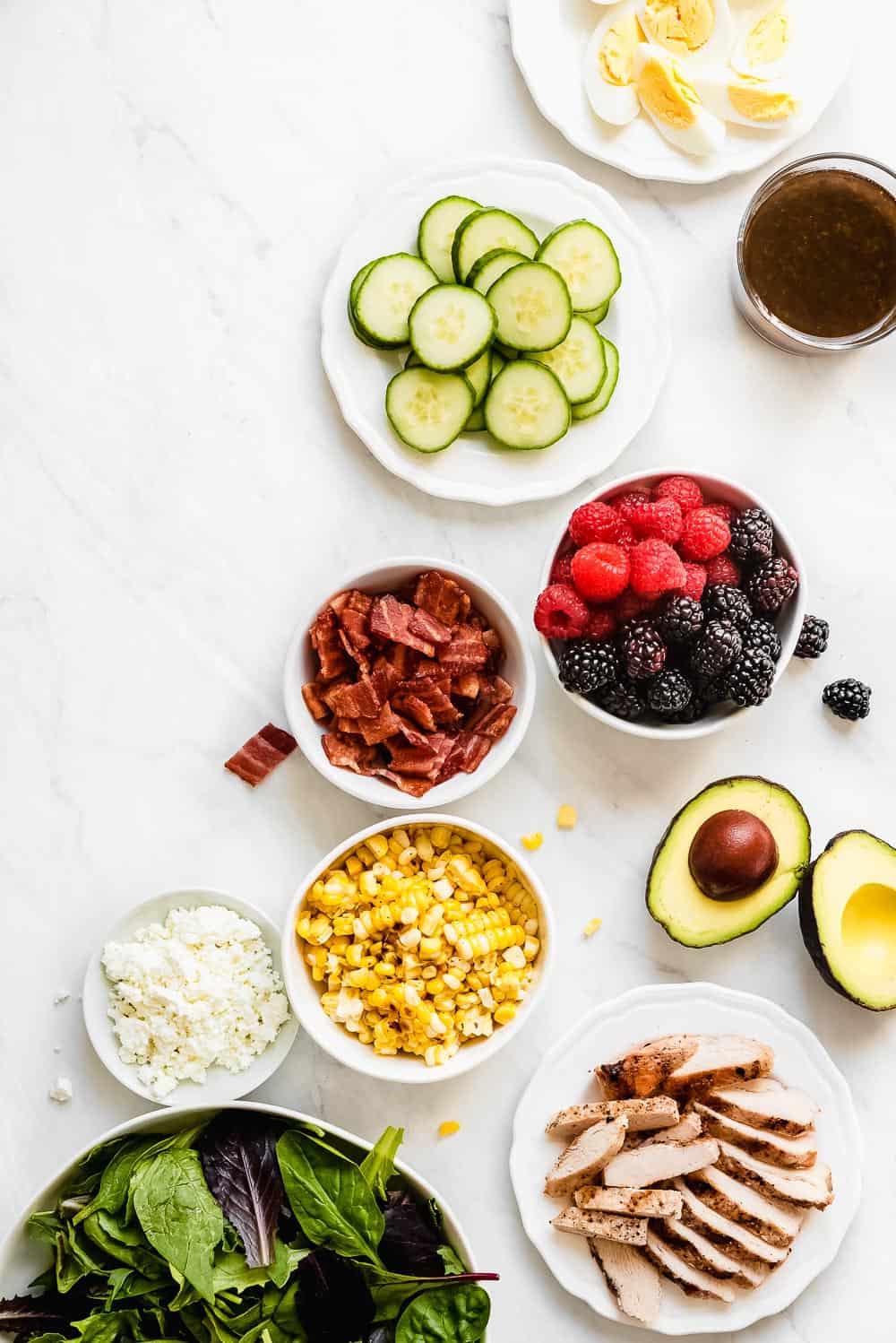 Summer cobb salad ingredients in separate bowls.