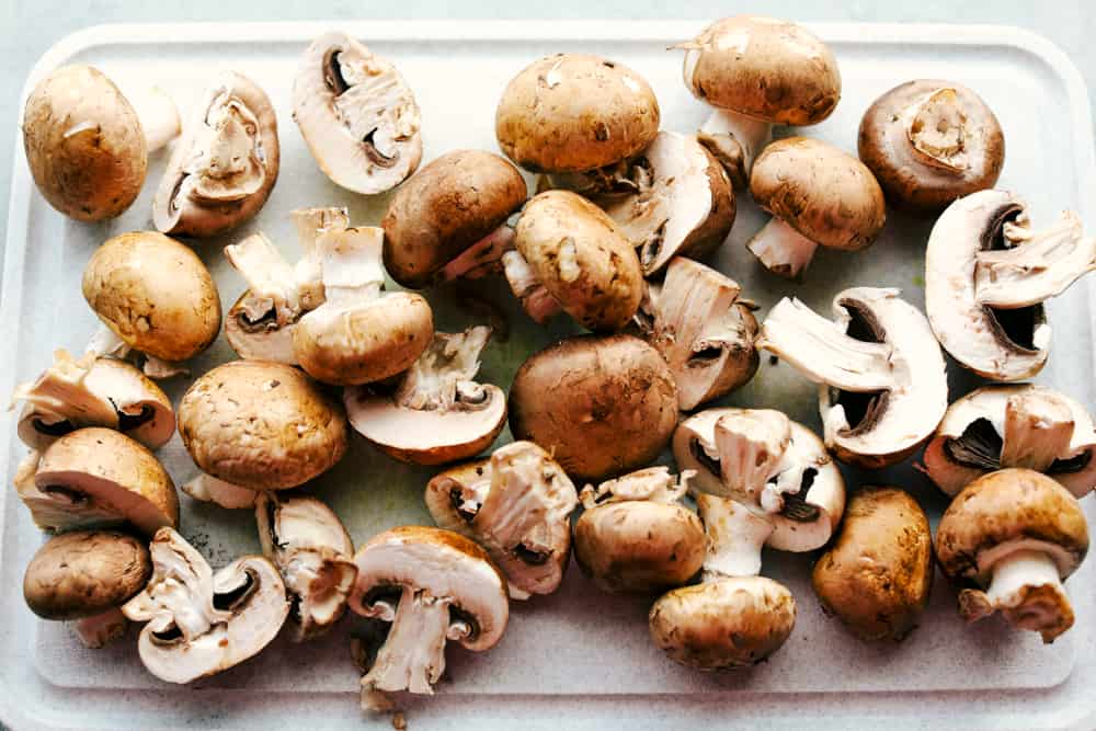 mushrooms being cleaned and prepped for sautéing 