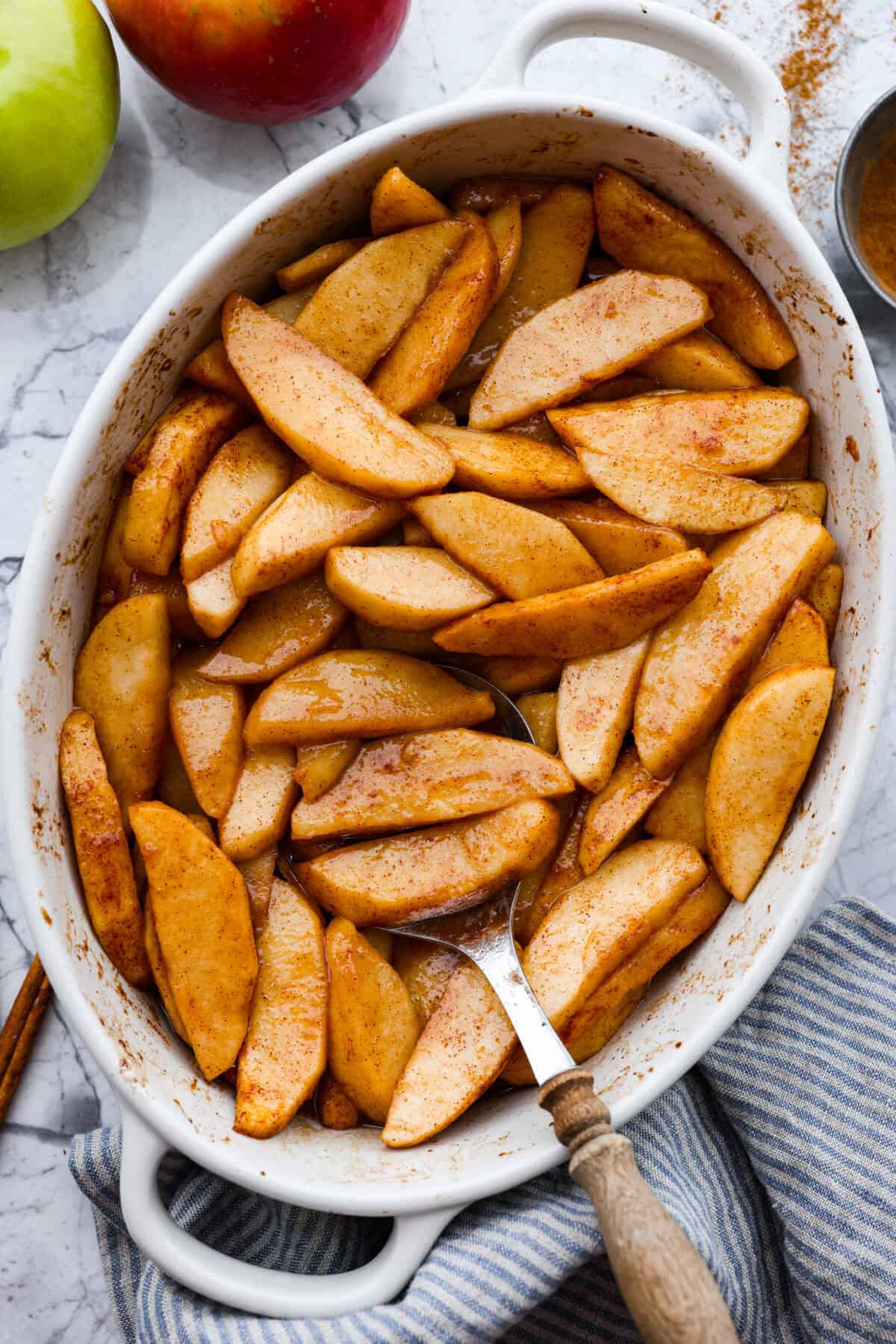 Overhead shot of a baking dish filled with brown sugar cinnamon baked apples. 