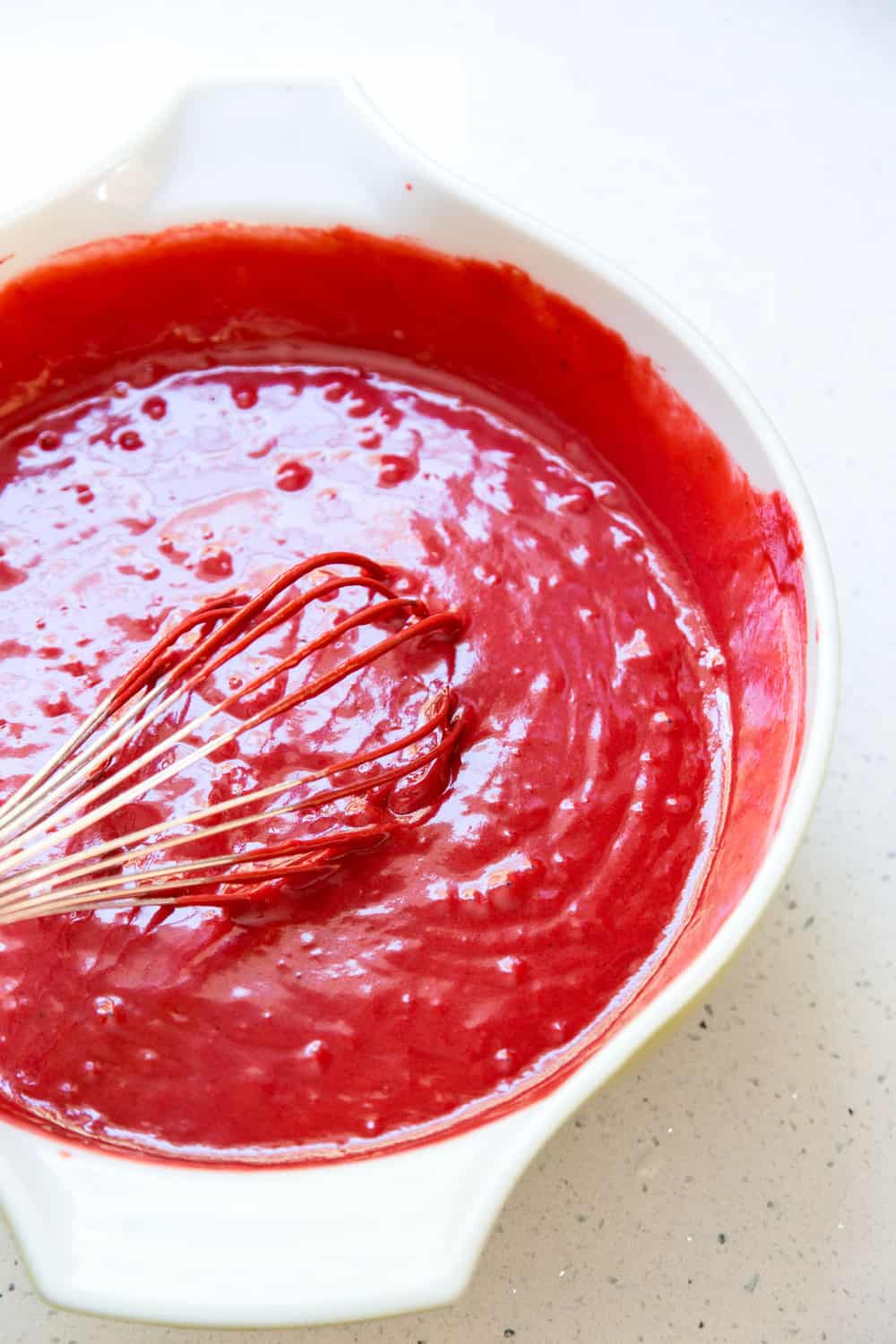 Red velvet cake batter in a mixing bowl