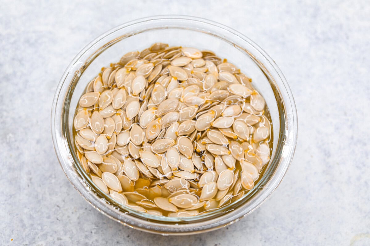 Overhead shot ofseeds in a bowl of warm water. 