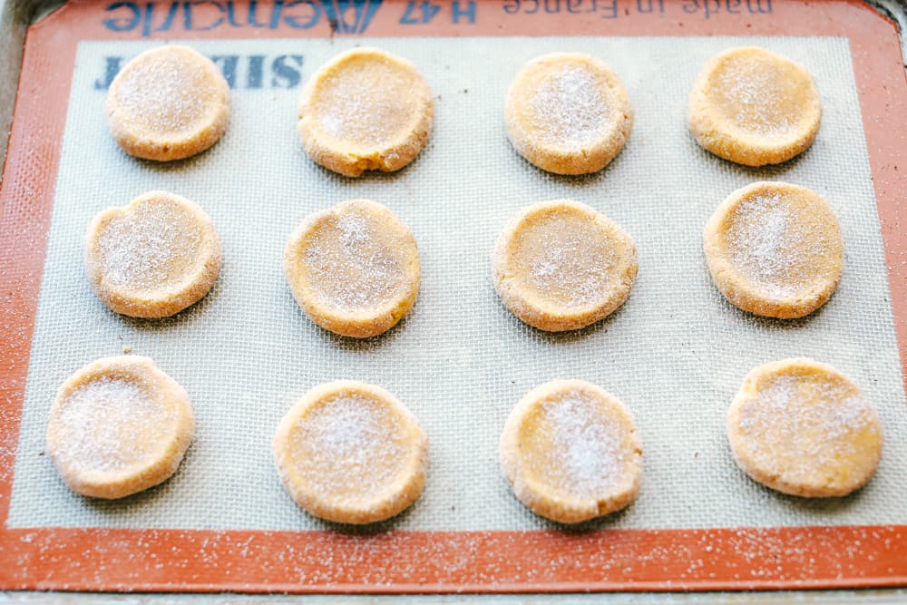 pumpkin snickerdoodle dough pressed down getting ready to bake.