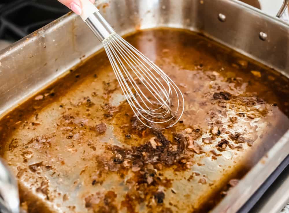 Drippings being whisked in a pan. 