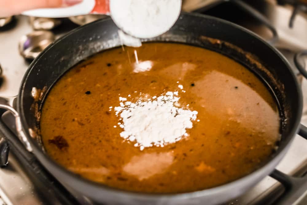 Adding the flour to the saucepan. 