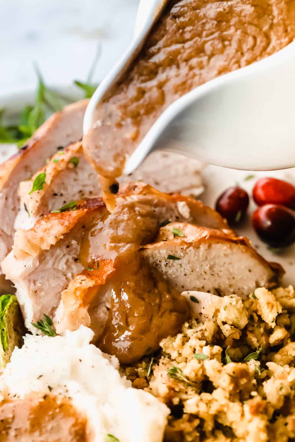 Pouring turkey gravy over the turkey