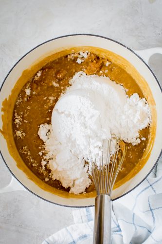 mixing powdered sugar into peanut butter fudge syrup