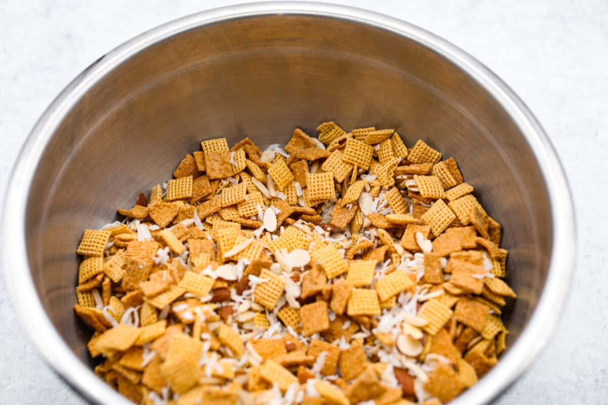 Overhead shot of cereal, coconut and almond mixture in a large bowl. 