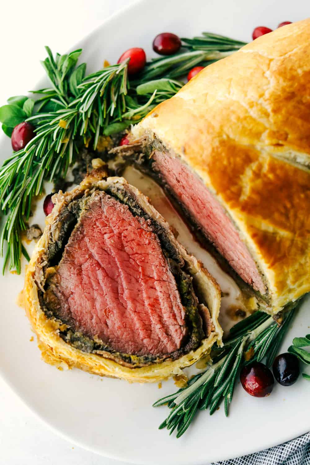 beef welling ton cut into a slice on a plate