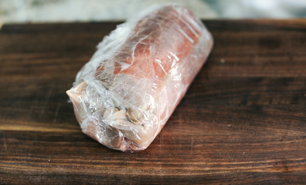 Tenderloin tightly wrapped in a plastic wrap 