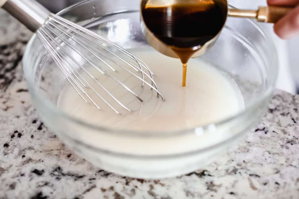 Adding ingredients to the bowl and whisking