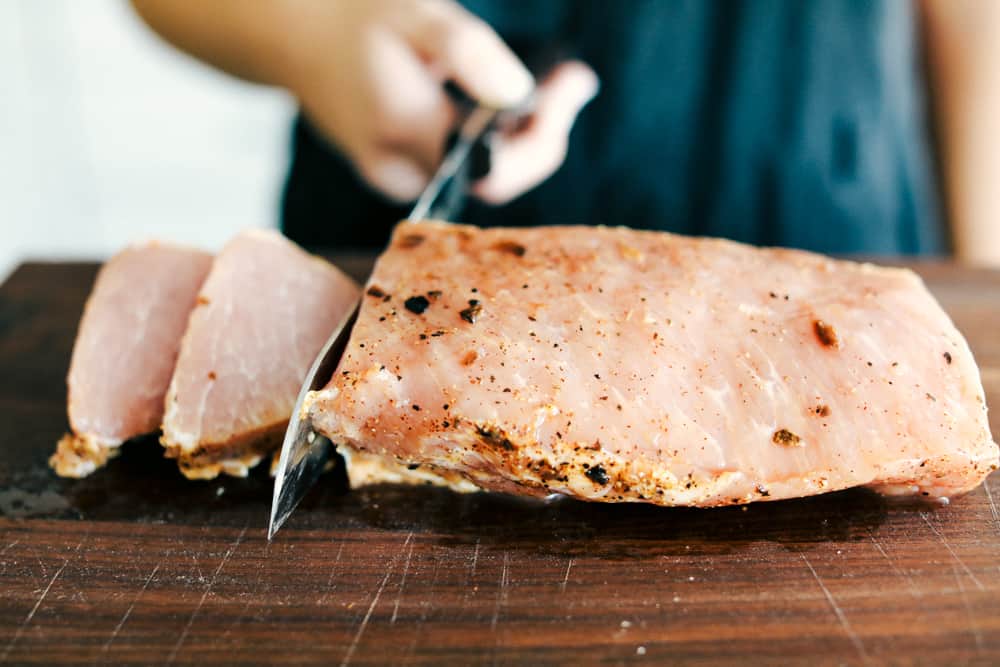 pork cut up into slices on a cutting board