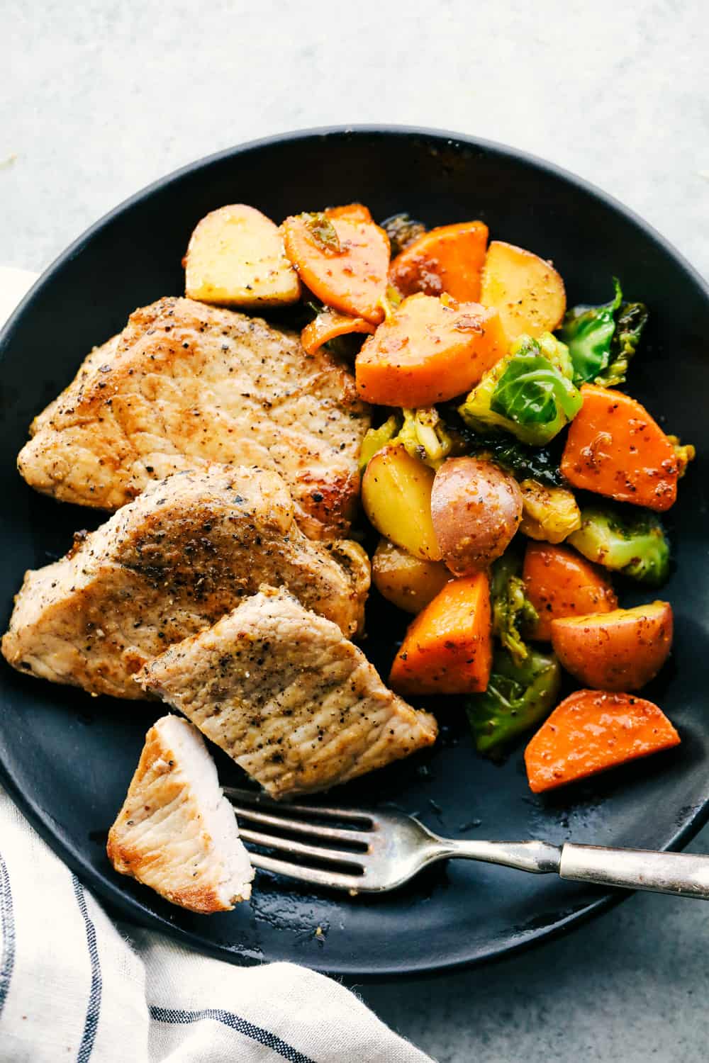 skillet pork chops with maple dijon vegetables on a plate 