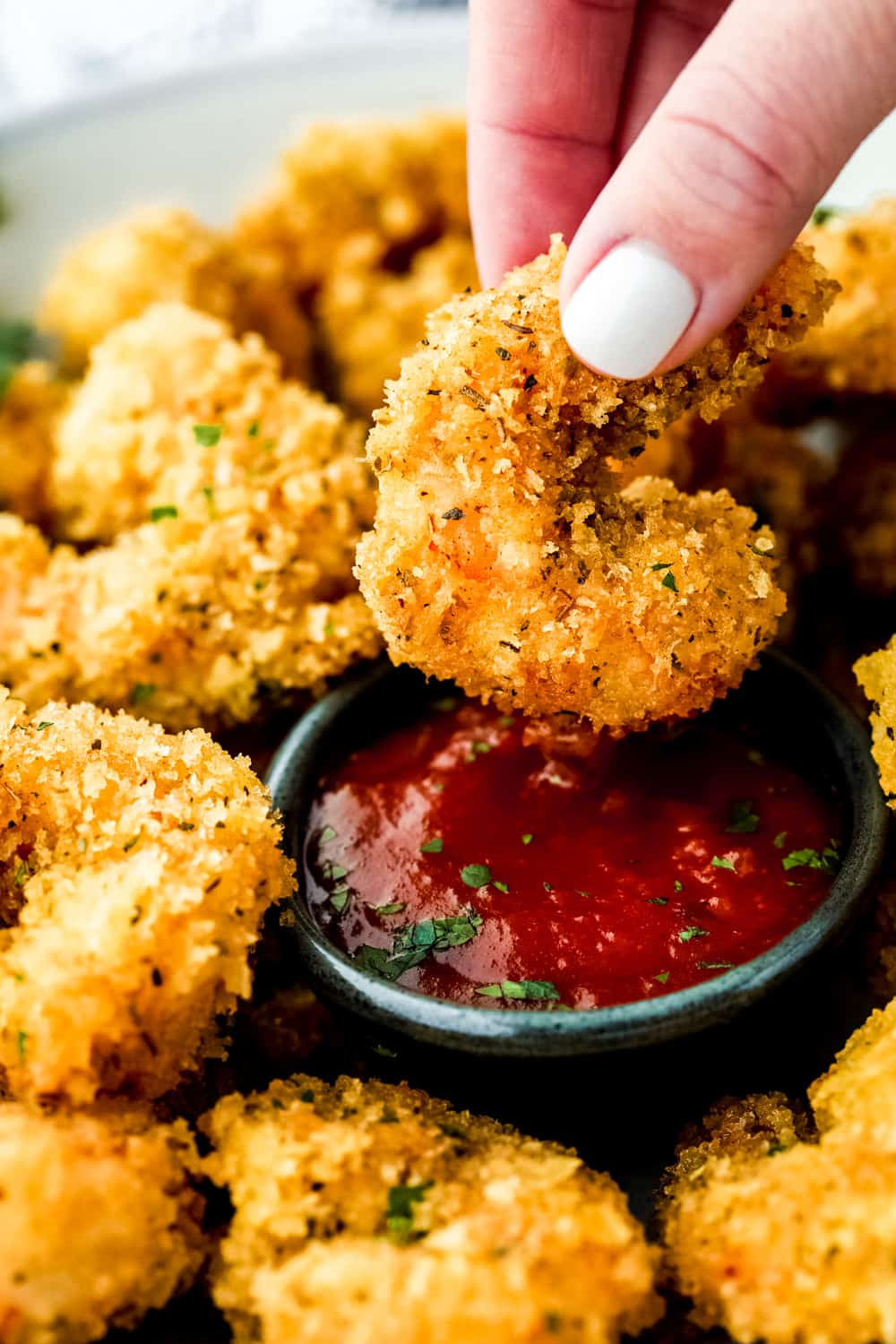 Cajun popcorn shrimp dipped in cocktail sauce. 