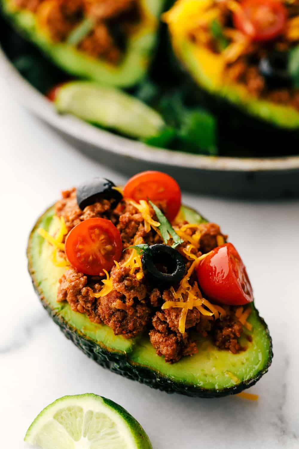 Turkey Taco Stuffed Avocado with a lime wedge. 