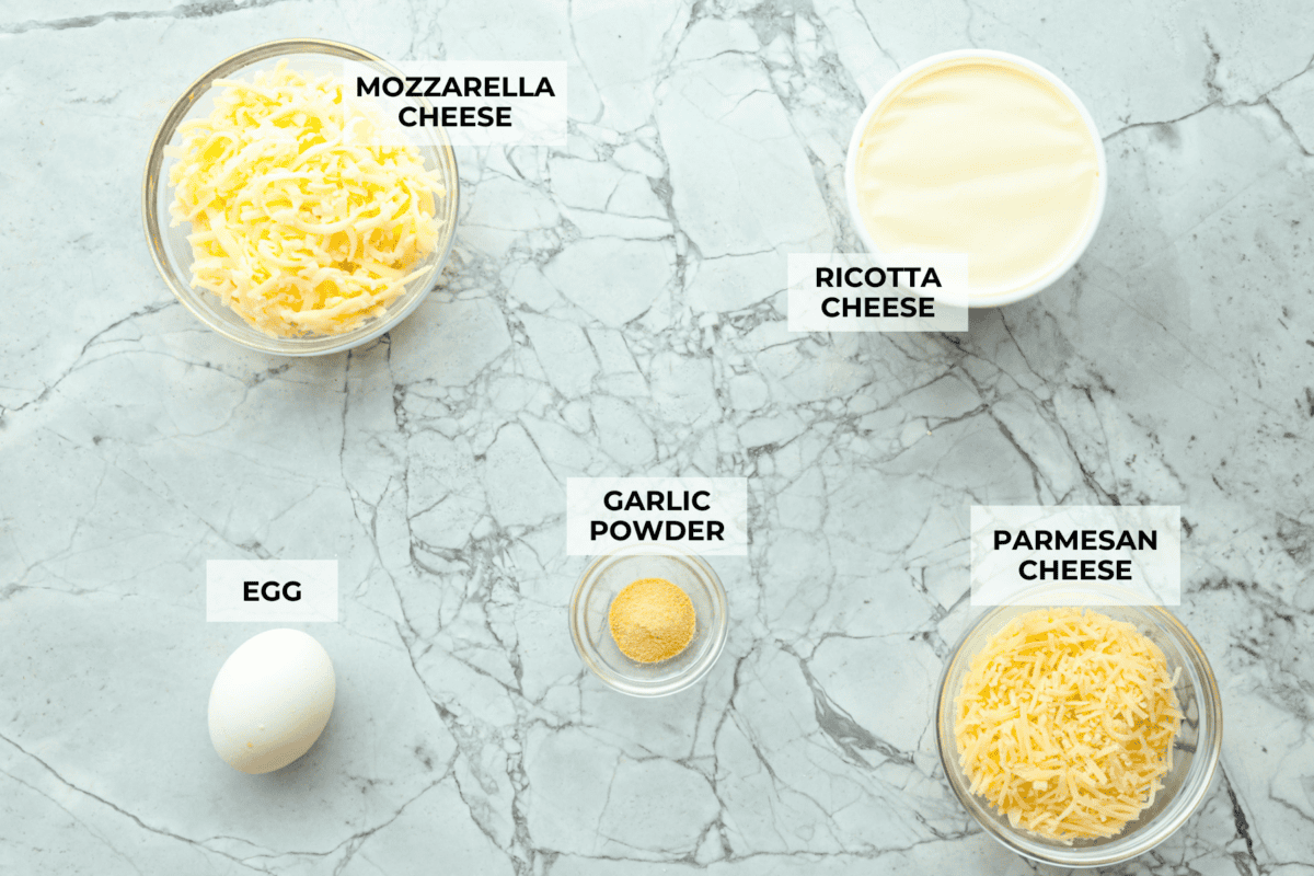 Overhead shot of labeled cheese mixture ingredients. 