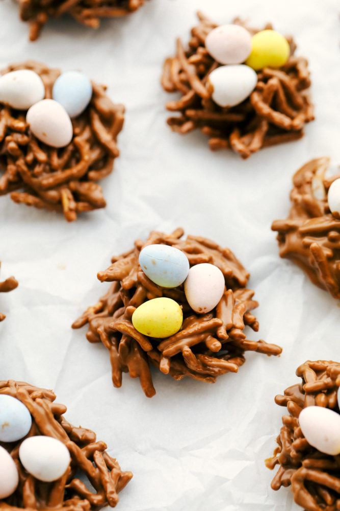 Birds nest on parchment paper with Cadbury eggs.