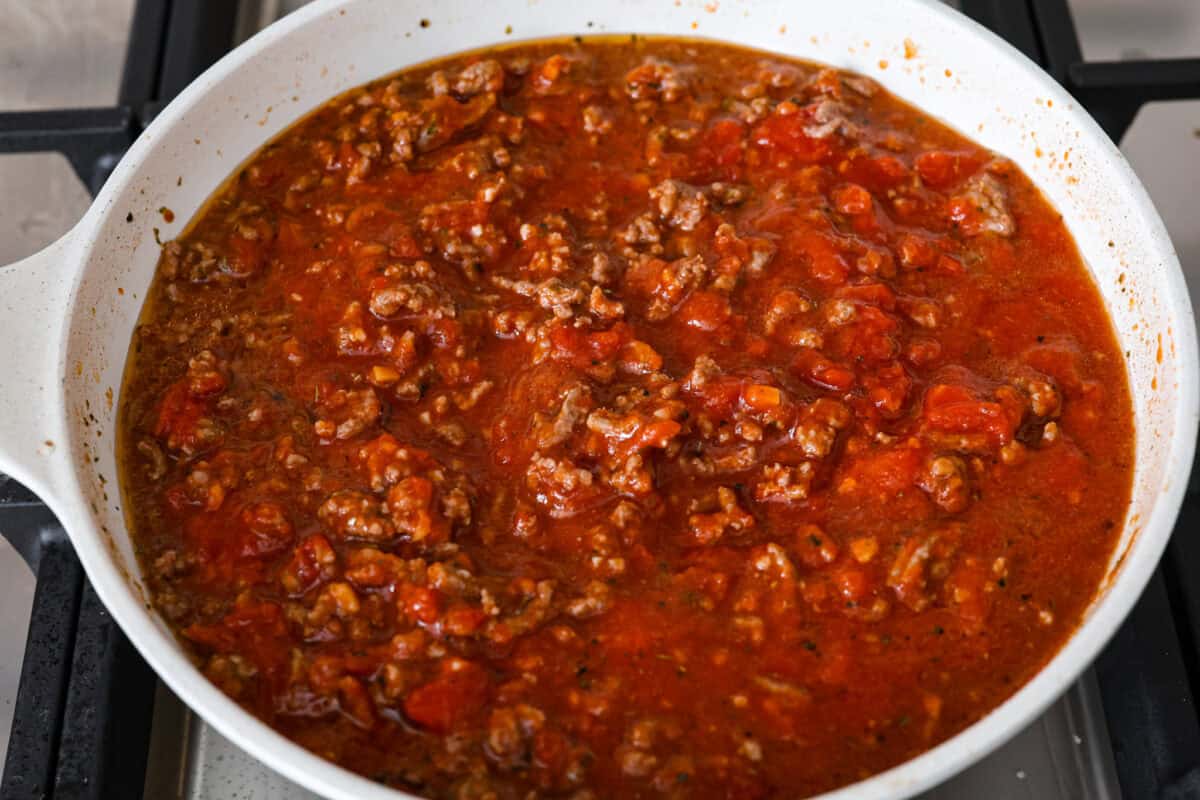 Overhead shot of beef and marinara sauce in a skillet. 