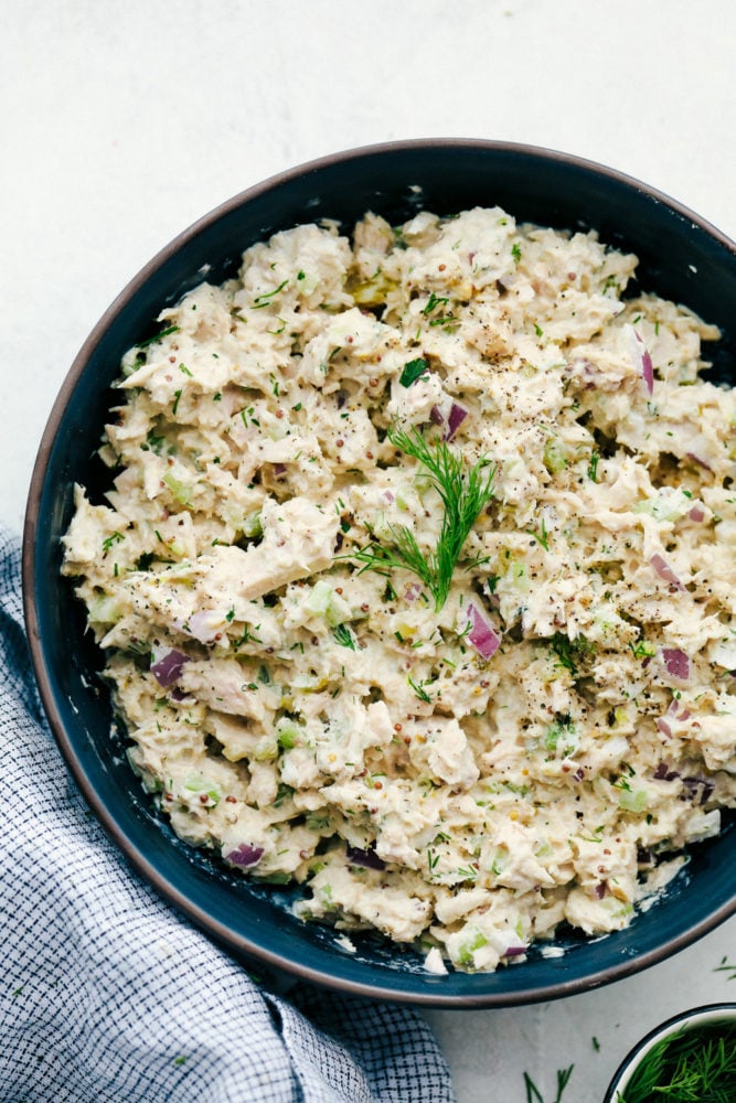 Tuna salad mixed together in a black bowl. 