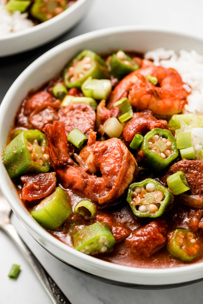 A close up shot of shrimp and okra in a bowl of Gumbo.