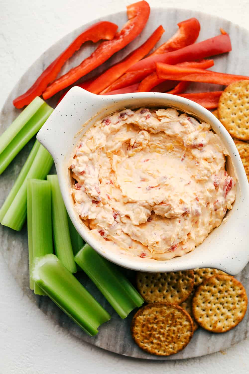 Creamy, cheesy pimento dip with veggies and crackers.