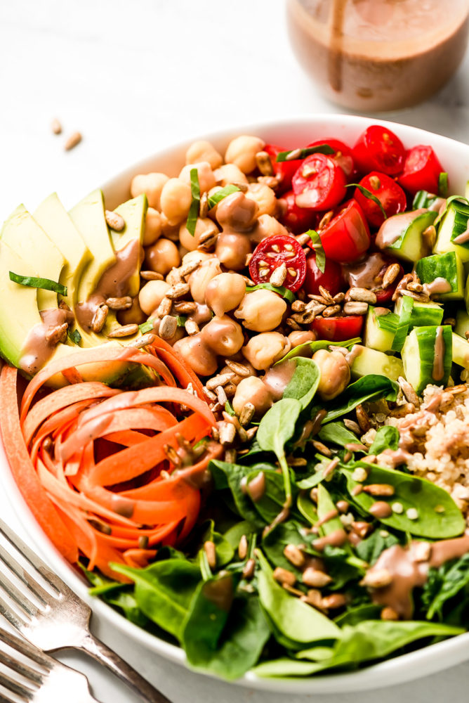 A close up shot of chickpeas and vegetables in a bowl.