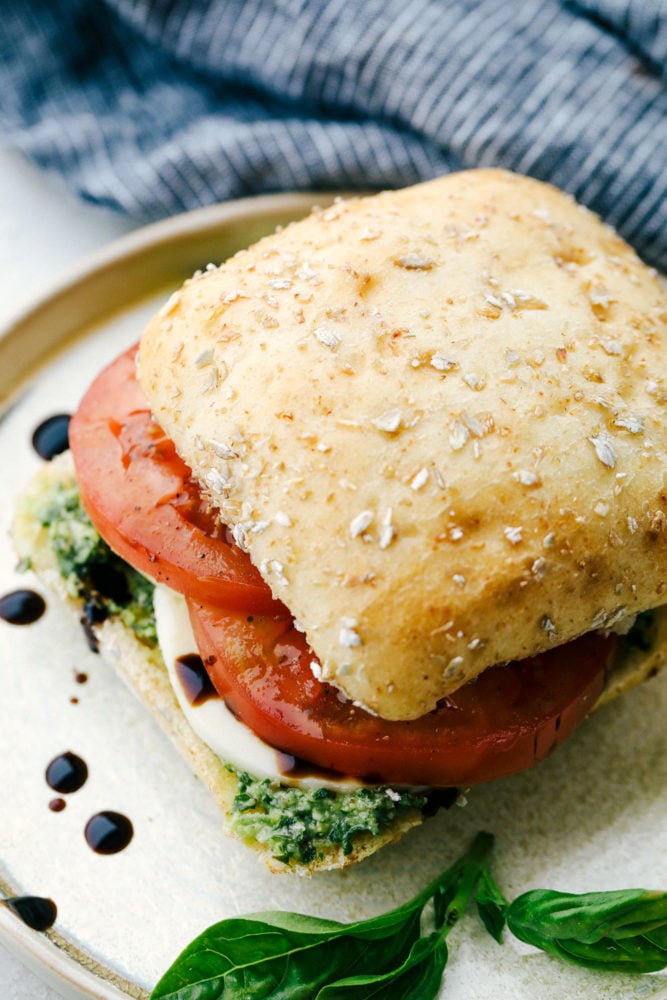 A finished caprese sandwich on a plate.