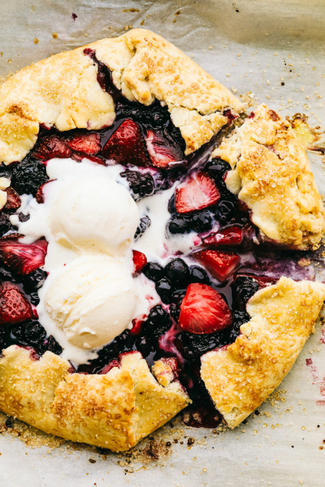 Finished Berry galette with two scoops of vanilla ice cream on top.