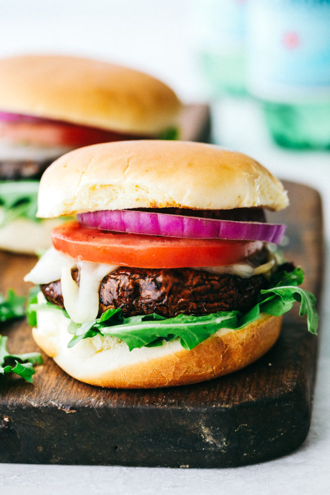 Finished portobello burger on a wooden board.