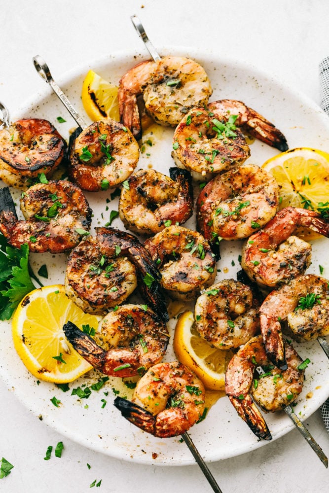 Grilled shrimp on a white plate.