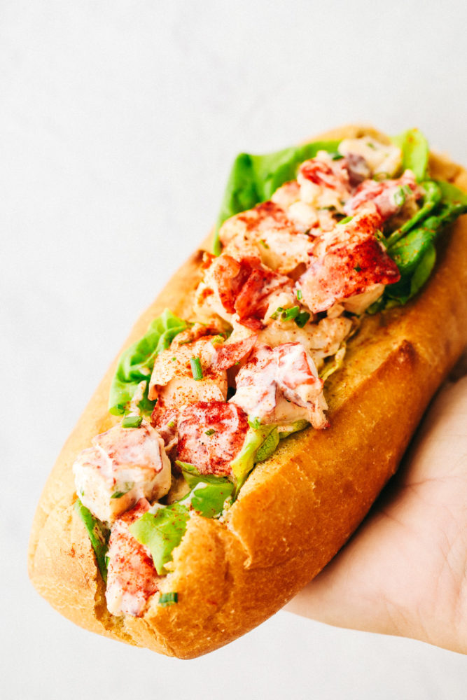 Holding a finished lobster roll.