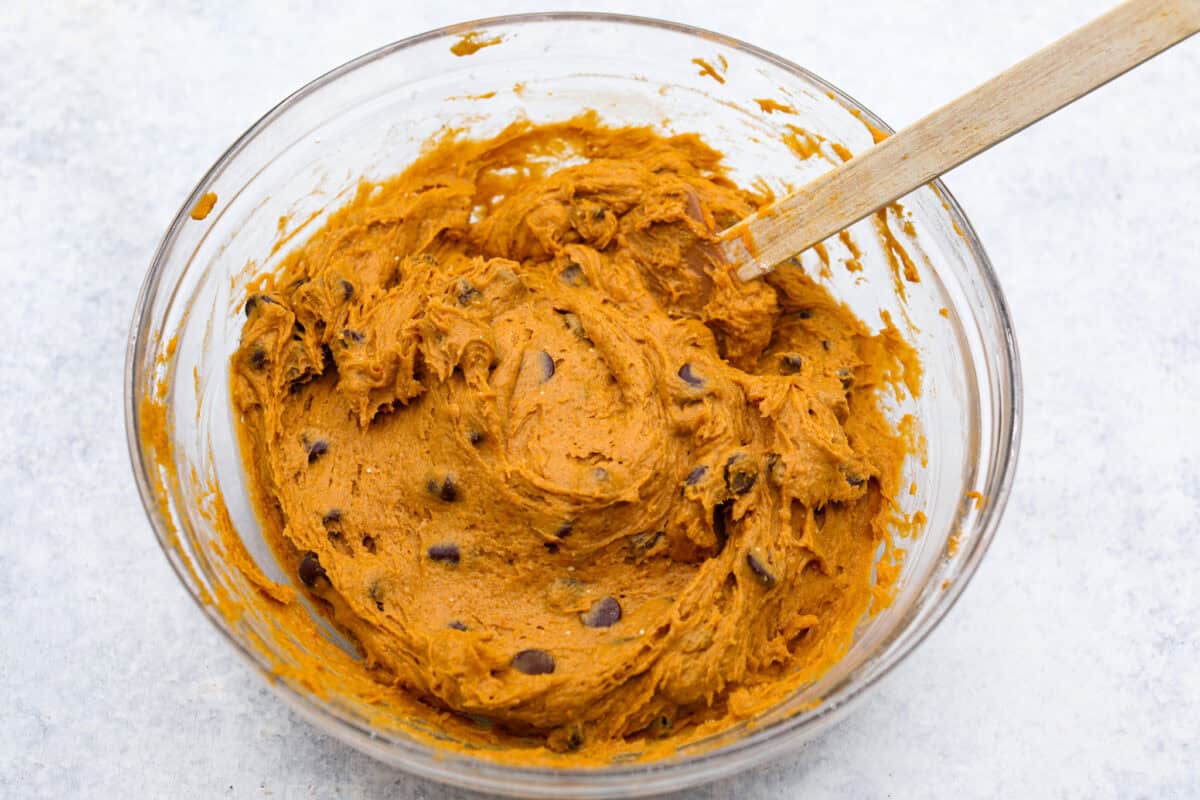 Overhead shot of chocolate chips mixed in to the puree and spiced cake mixture. 