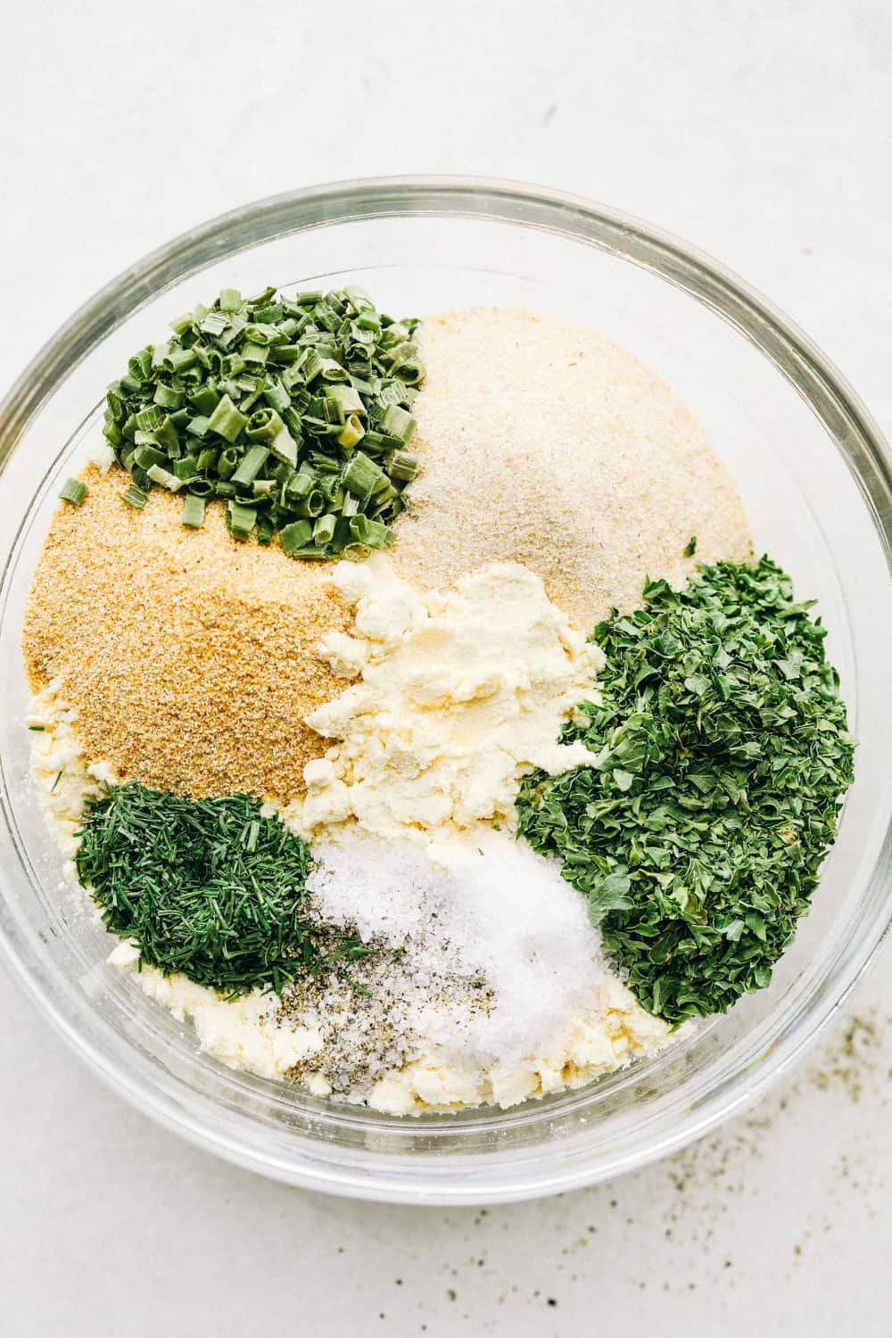 A glass bowl filled with all the seasonings.