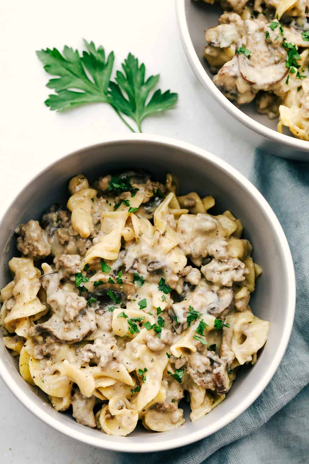 A serving of the creamy beef and noodles in a white bowl.