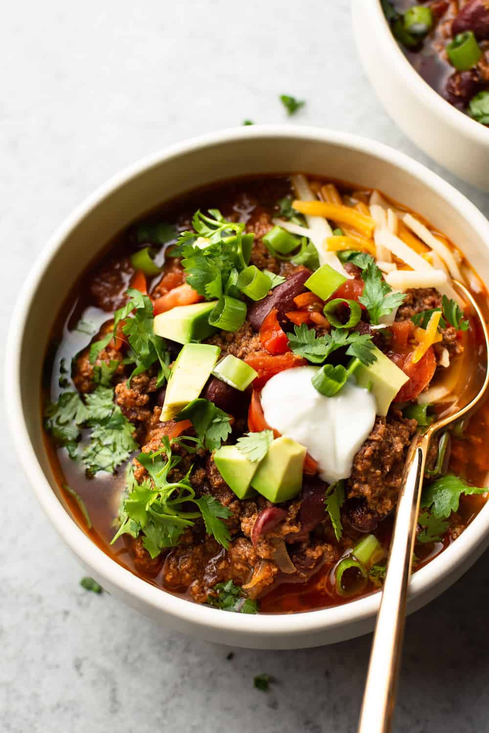 Instant Pot chili in a bowl with a gold spoon