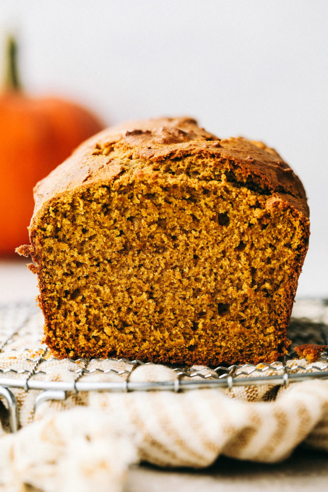 Perfectly spiced moist and tender pumpkin bread on a wire rack.