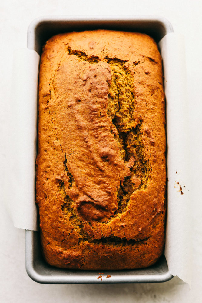 Perfectly spiced moist and tender pumpkin bread in a loaf pan. 