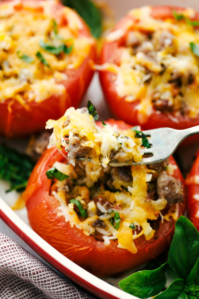 Cheesy Stuffed Tomatoes with Sausage are tomatoes stuffed with a hearty sausage and rice filling and topped with gooey cheese.